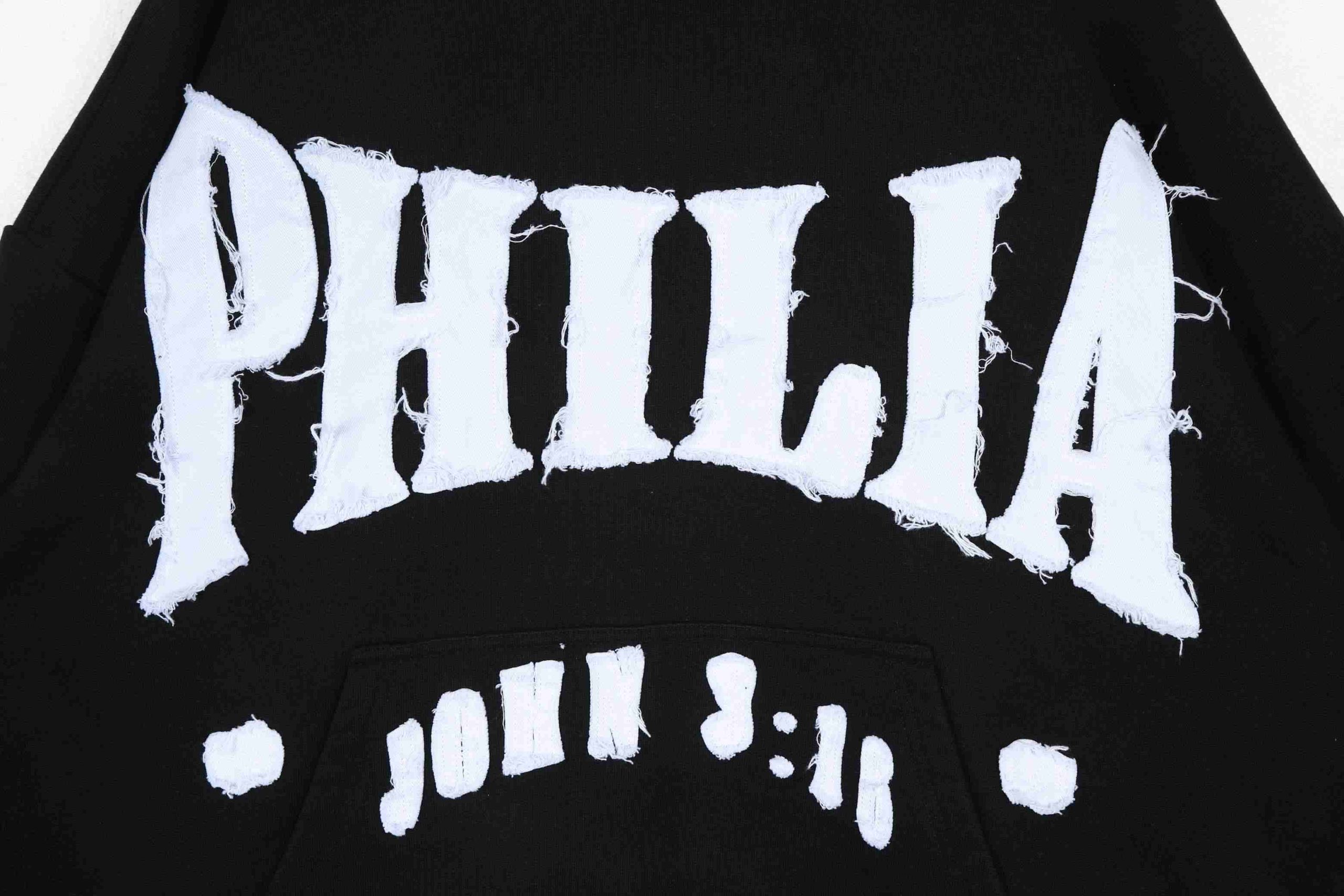 Appliqué embroidery detail on custom knitwear sweater