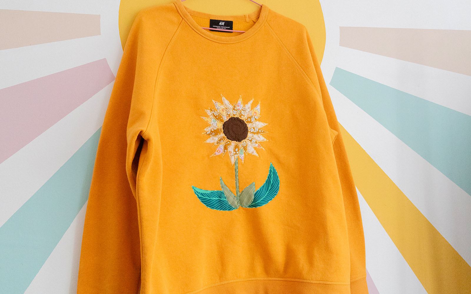 Embroidered applique sweater with custom design details
