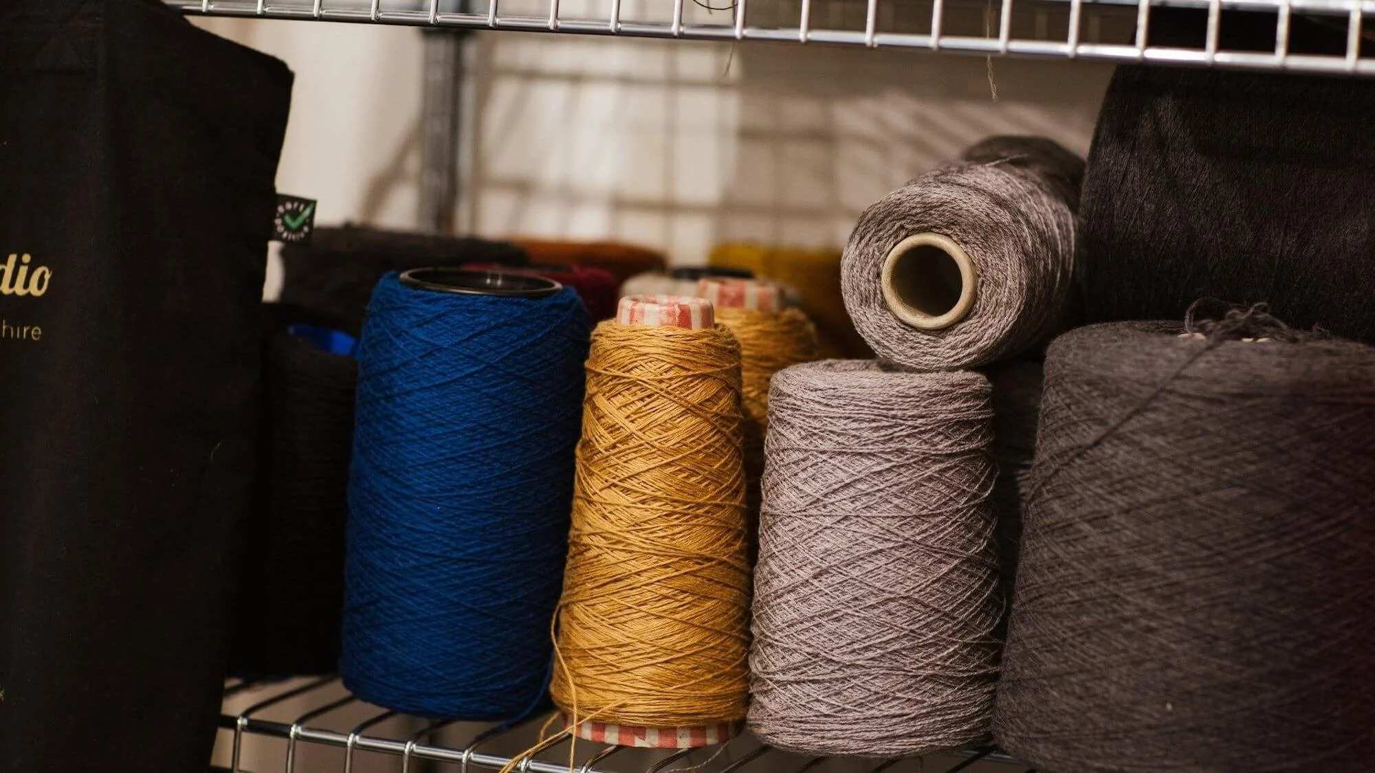 Knitwear yarn spool for custom sweater production