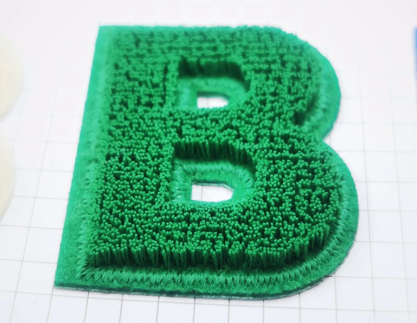 Plush embroidery detail on custom sweater